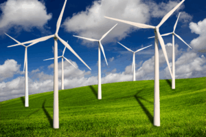 7 Windmills in the countryside on a sunny day to showcase renewable energy resources. 